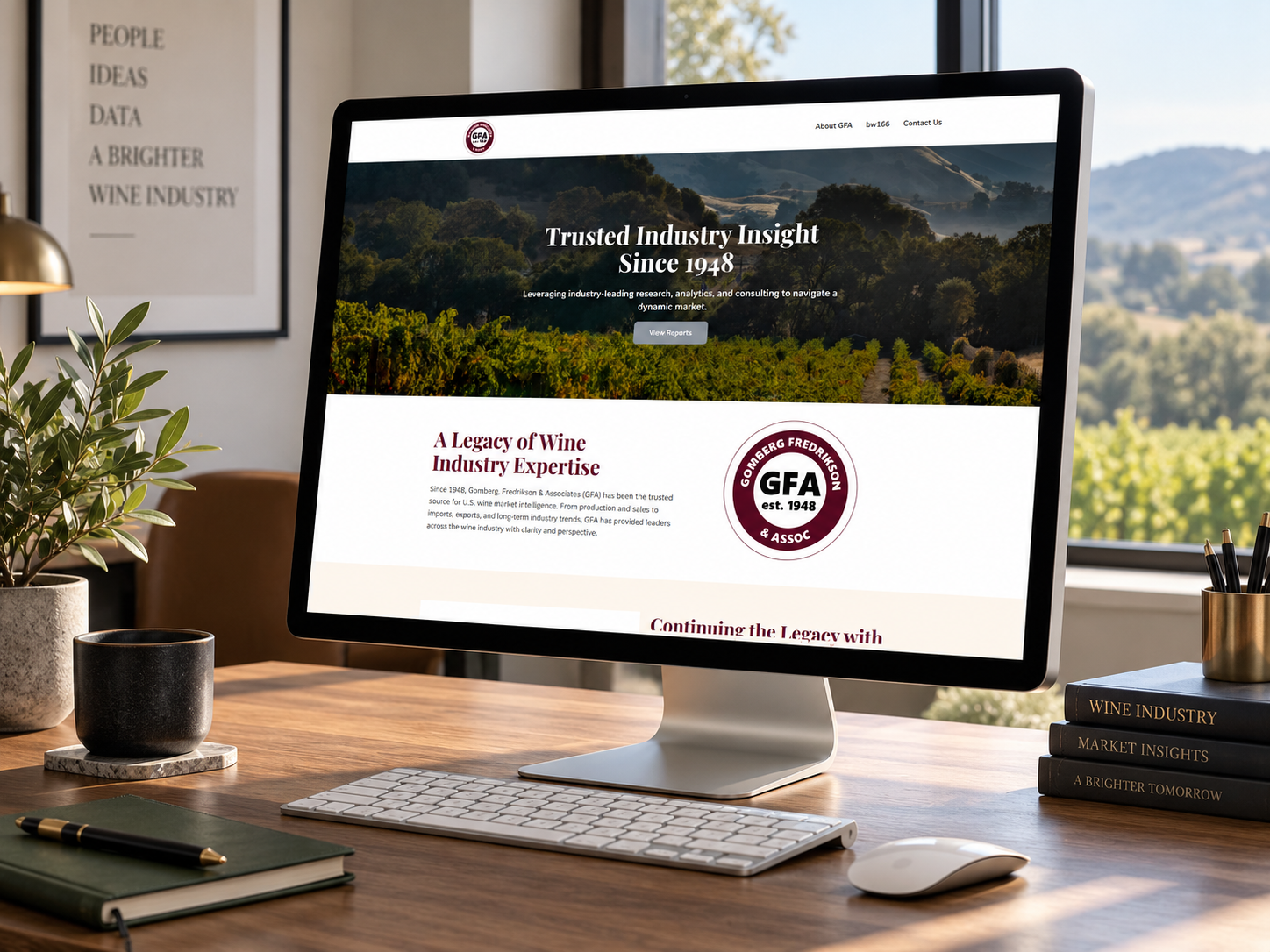 GFA Wine website displayed on iMac sitting on wood grain desk.