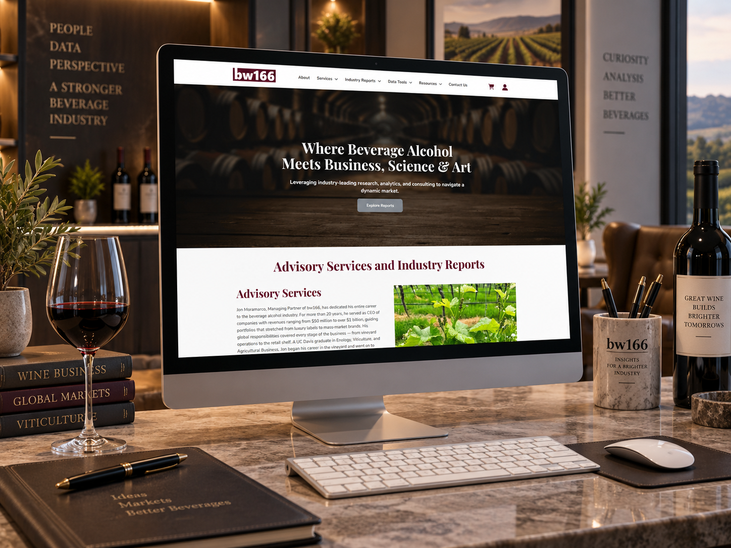 bw166 website on iMac sitting on wood grain desk.
