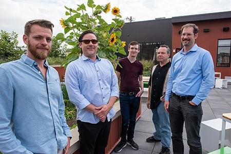 team photo of Colorado Digital employees in front of sunflowers
